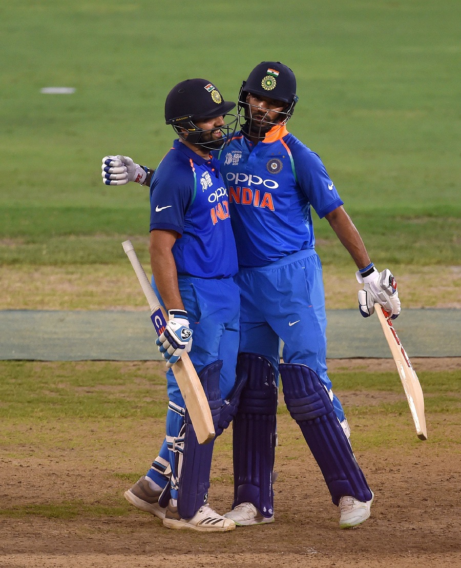 Indian cricket team captain Rohit Sharma (L) and teammate Shikhar Dhawan greet each other during the ODI. PHOTO: AFP