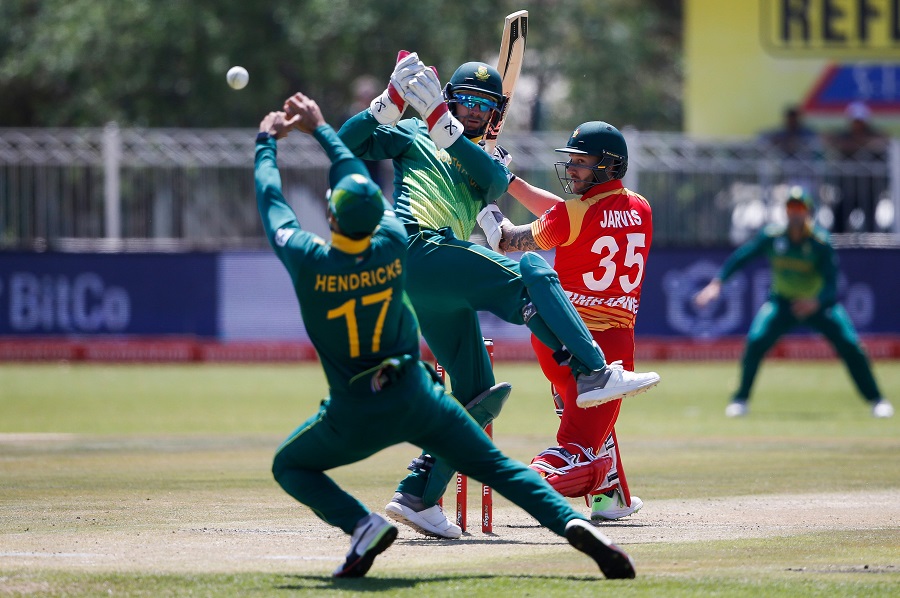 Zimbabwe's Kyle Jarvis (R) looks on as South Africa's Reeza Hendricks (L) misses the catch after South Africa's Imran Tahir bowled. PHOTO: AFP