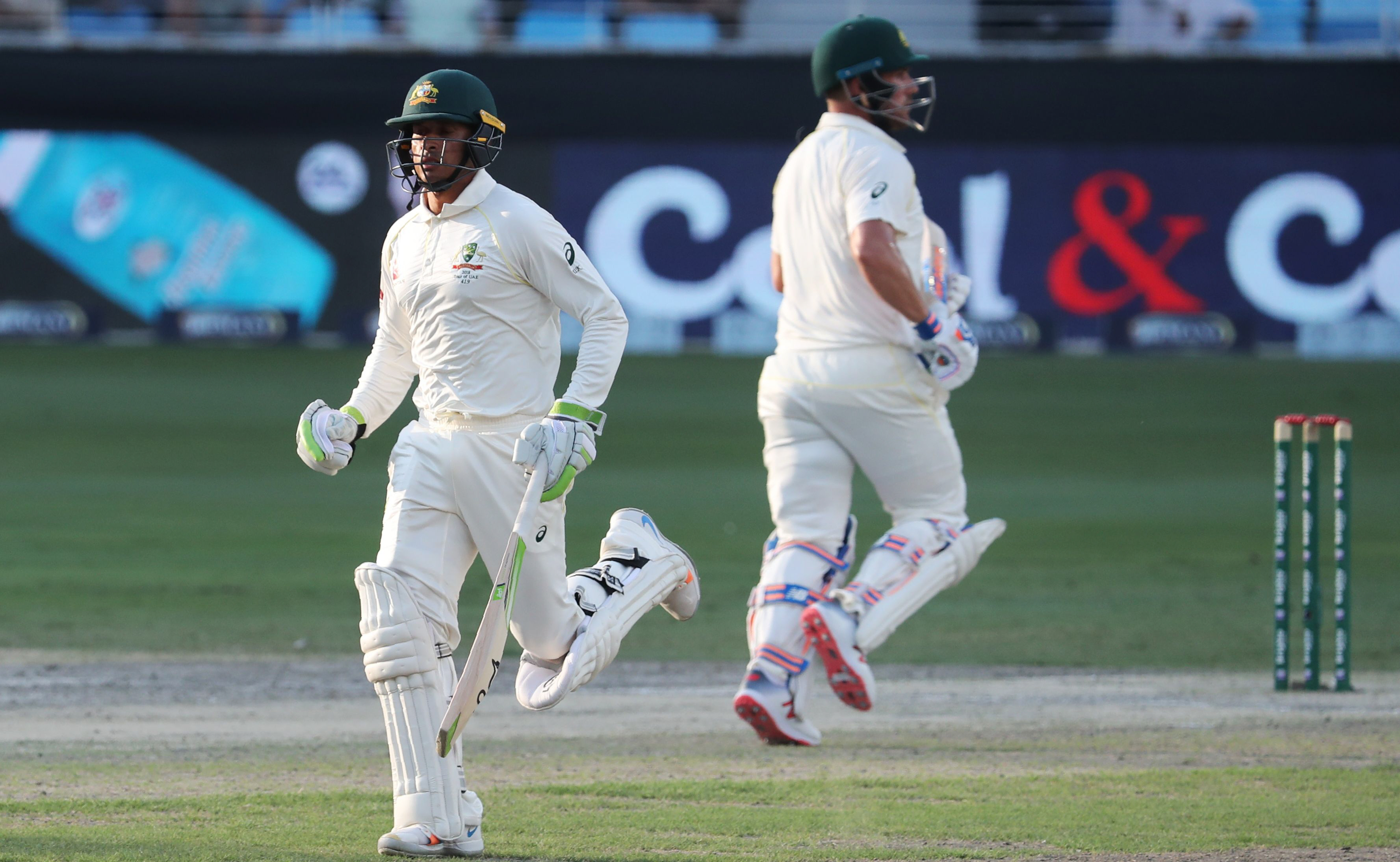 1.	Australian cricketers Usman Khawaja (L) and Aaron Finch (R) run between the wickets during the second day of the First Test match in the series between Australia and Pakistan at the Dubai International Stadium in Dubai on October 8, 2018. (Photo by KAR