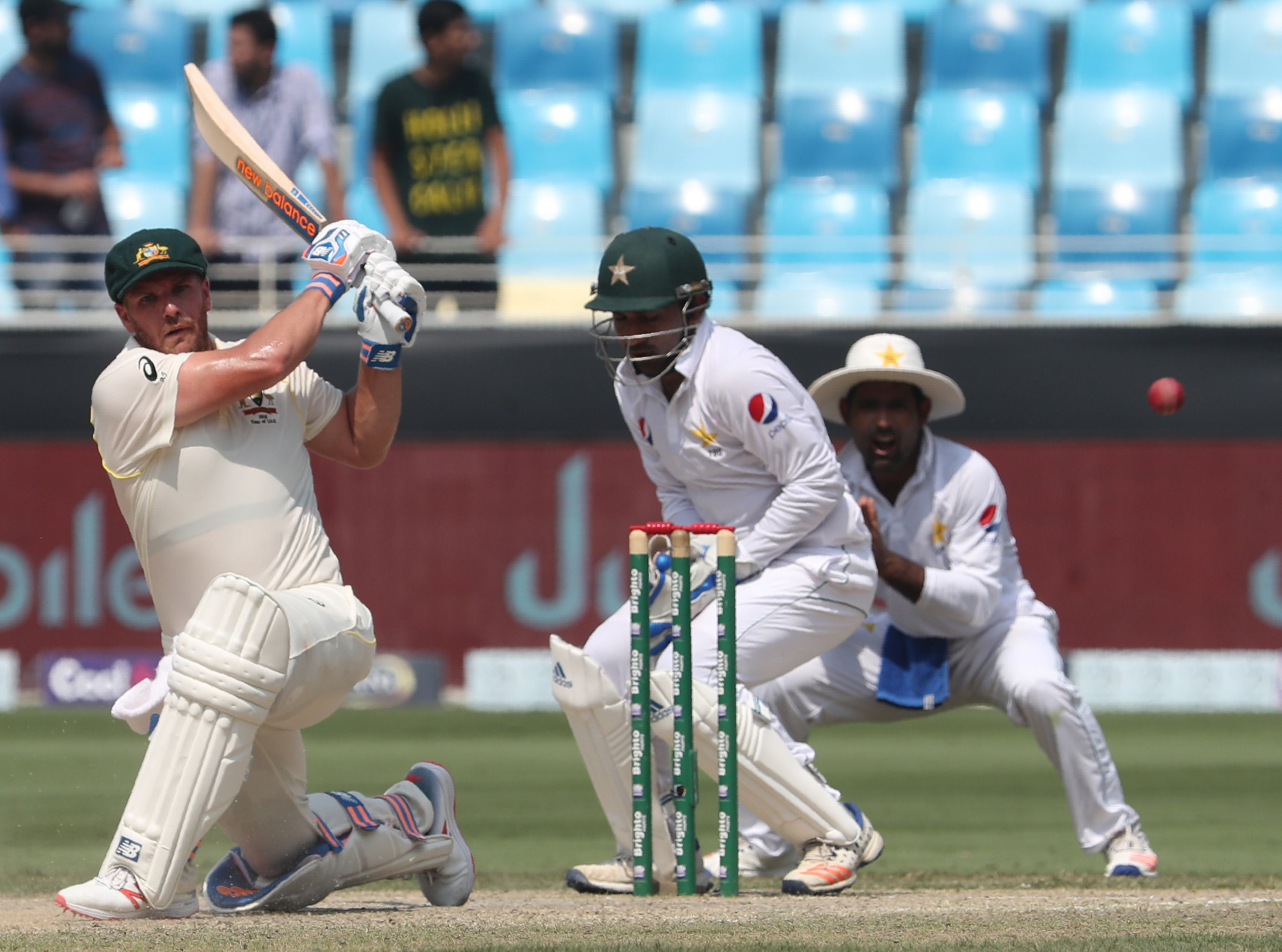 1.	Australian cricketer Aaron Finch (L) plays a shot during the third day of play of the first Test cricket match in the series between Australia and Pakistan at Dubai International Stadium in Dubai on October 9, 2018. (Photo by KARIM SAHIB / AFP)