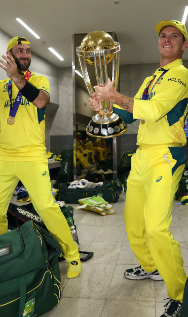 Zampa and Maxwell celebrate with the trophy