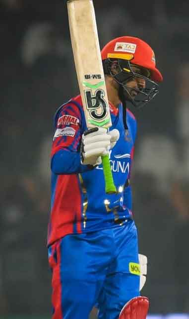 Shoaib Malik raises his bat after scoring fifty