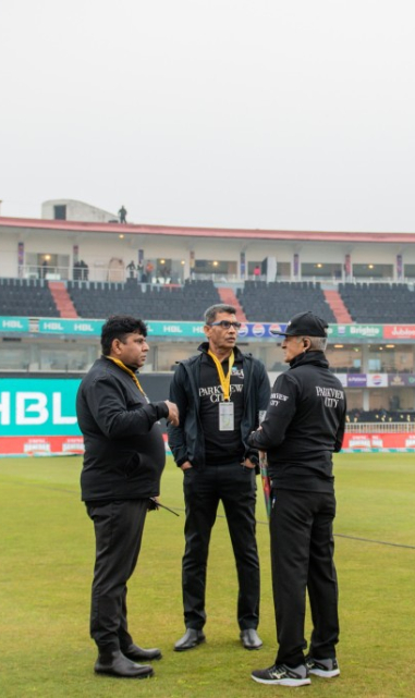 Match officials having discussion regarding the condition