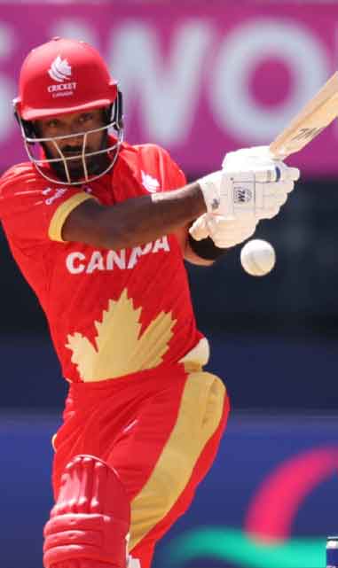 Shreyas Movva hits the ball for a boundary